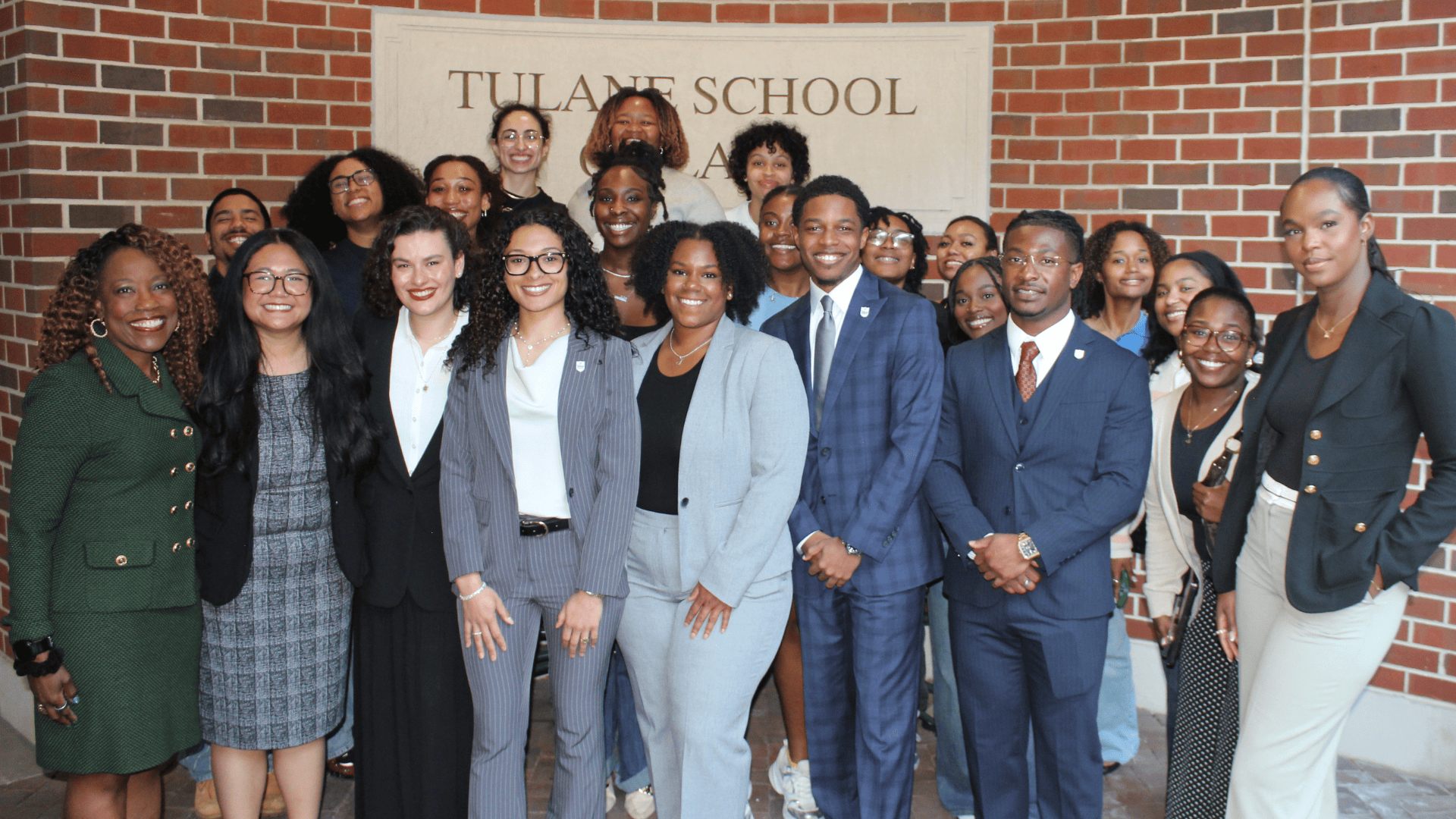 Smiling group of professionals at Tulane Law School.