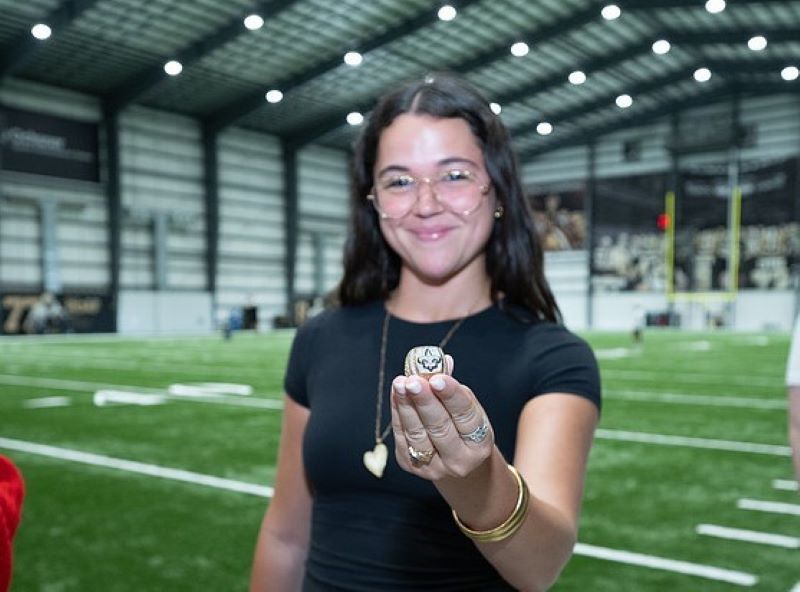 Student holding Saints ring at Sports Institute