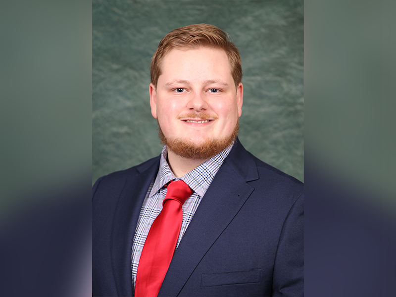 Wyatt Beaver smiles for a professional headshot.