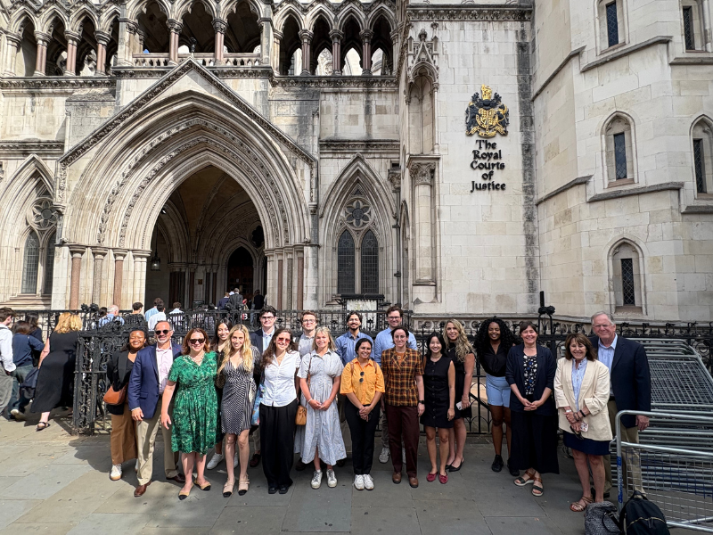 Students pose for a photo outside of the Royal Courts of London.