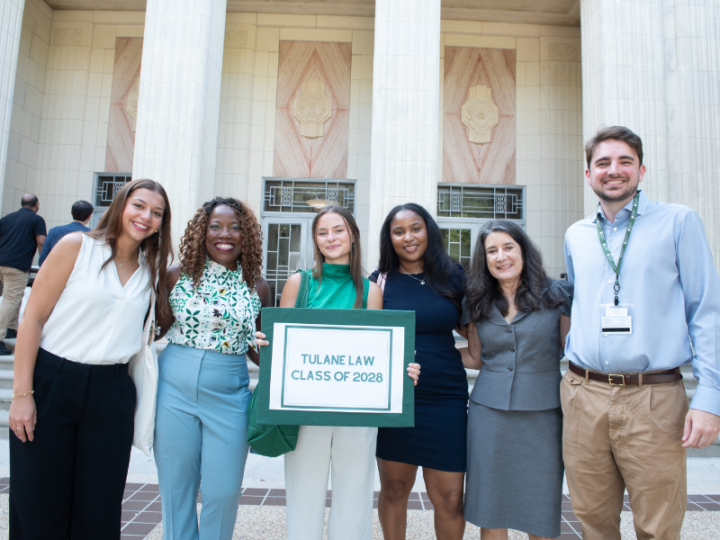Students pose with Dean Burke in front of McAlister Auditorium.