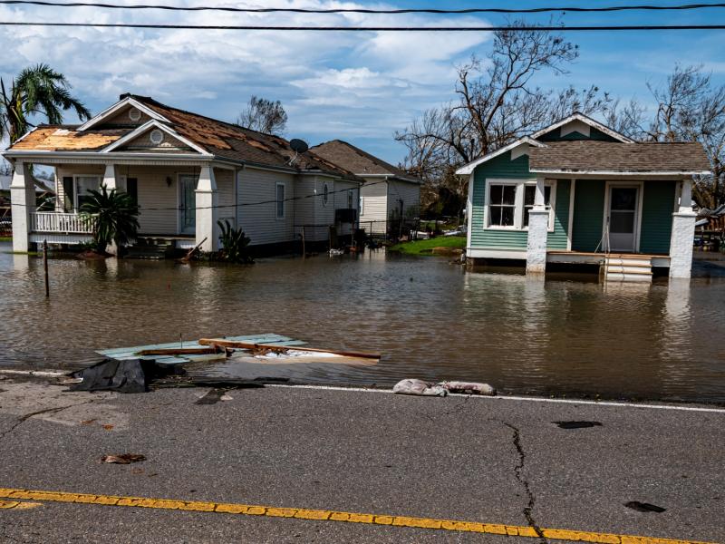 Two damaged homes in floodwaters.