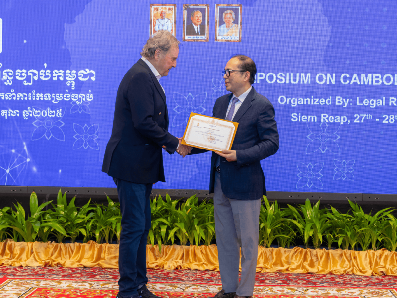 Professor Palmer receives a certificate at an event.