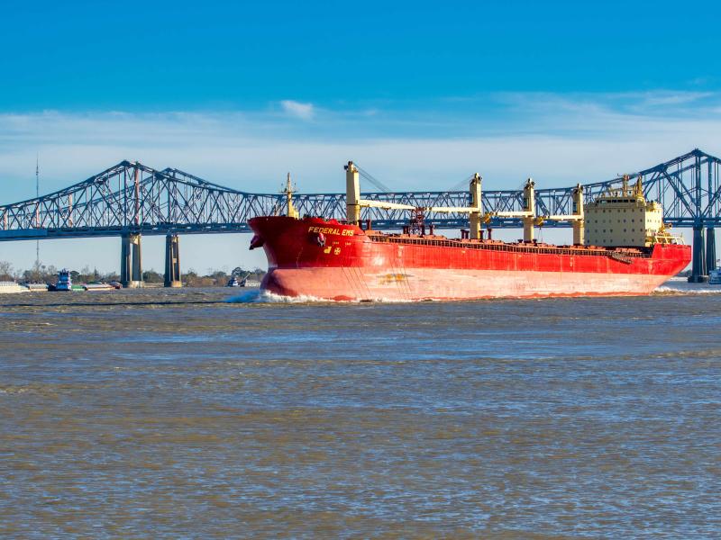 Red cargo ship on the Missisippi River In New Orleans