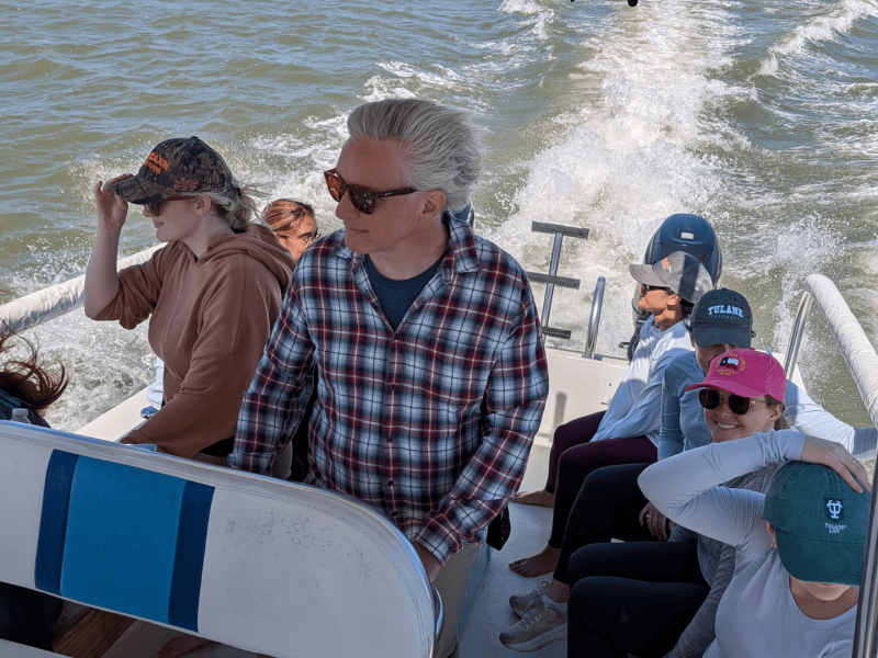 Field trip goers ride a boat through the waters of the lake.