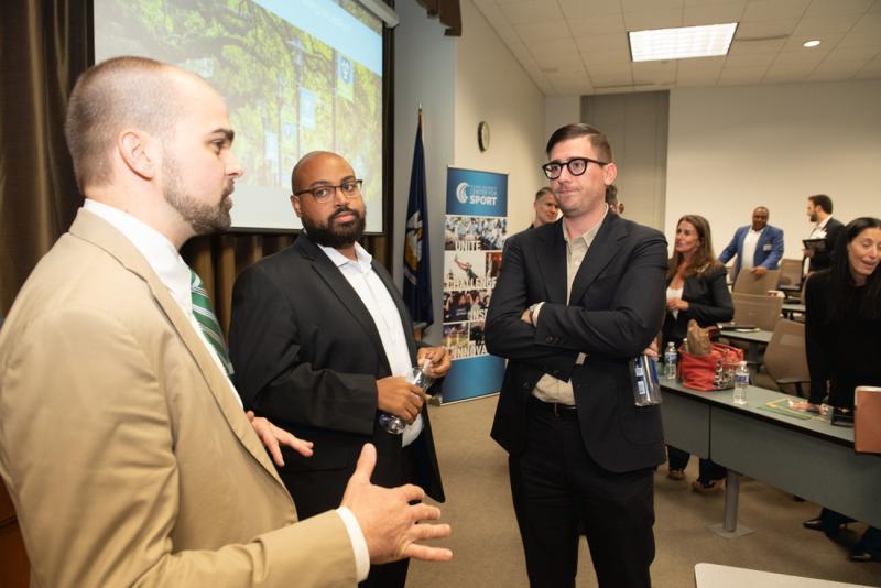 Edwards, right, and Robinson, center, are still engaged in both the basketball competition and in mentoring Tulane Law students. Here, they speak with Sports Law Program Manager Eric Blevins (L'11) during the 30th anniversary of Tulane's top-ranked program.