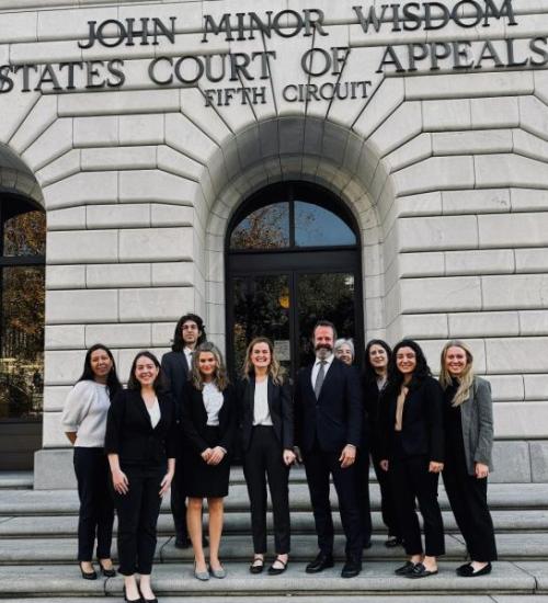 Neilson, Reeves and Brandao with faculty and students  who watched them argue the case in court.