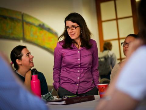 Professor and students engaged in discussion