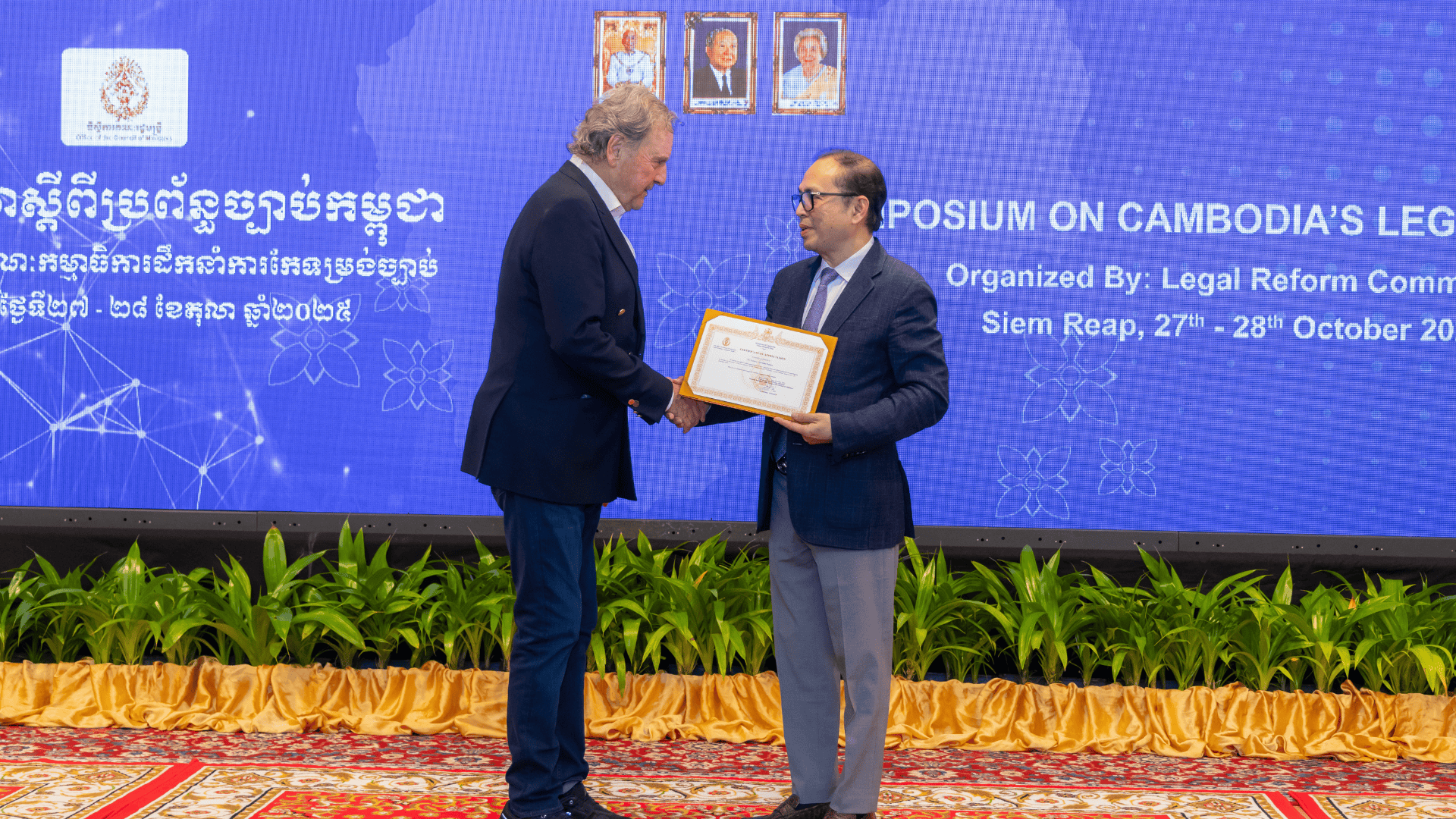 Professor Palmer receives a certificate at an event.