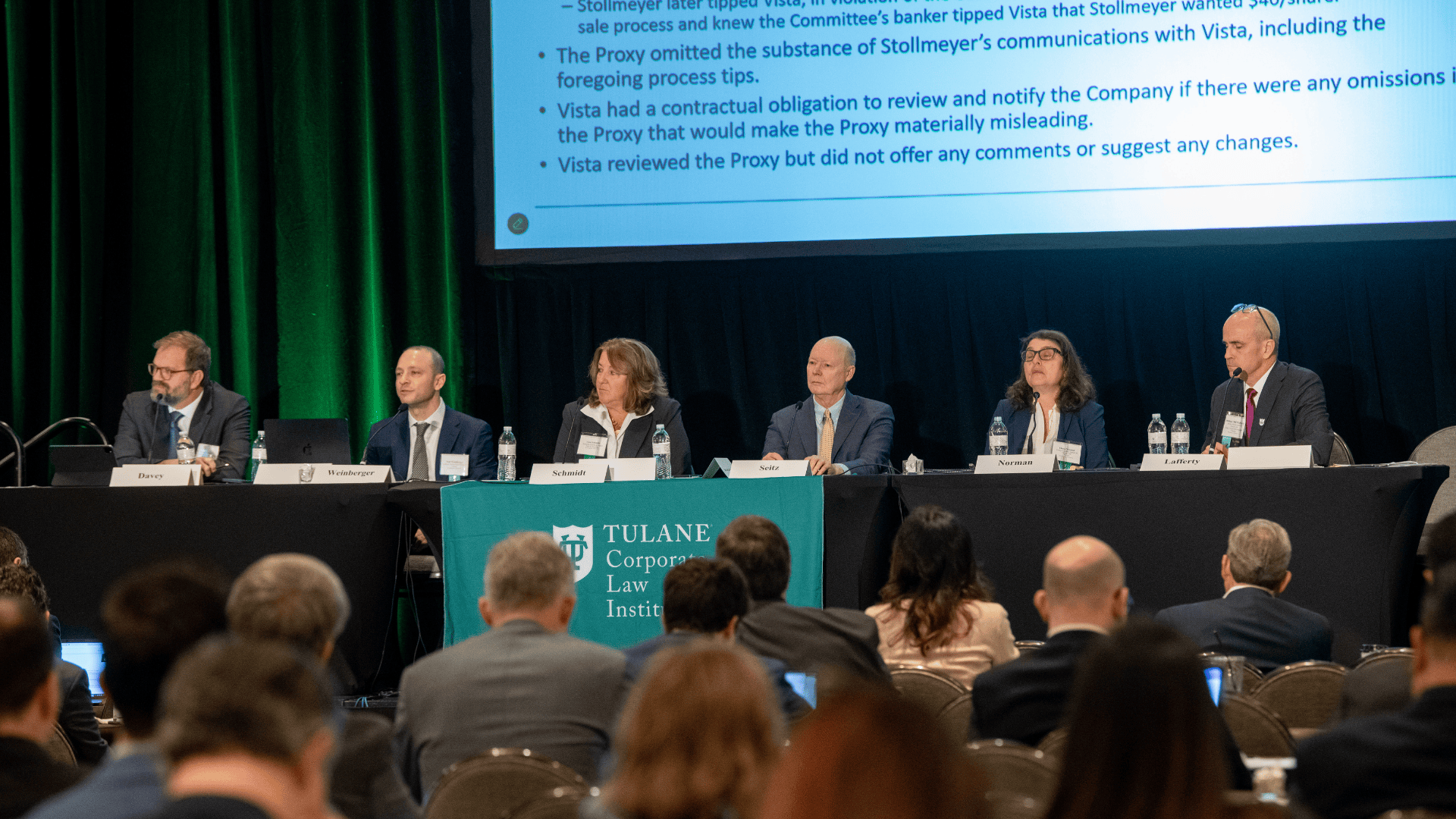 Six professionals on a panel at a Tulane University Law School conference.