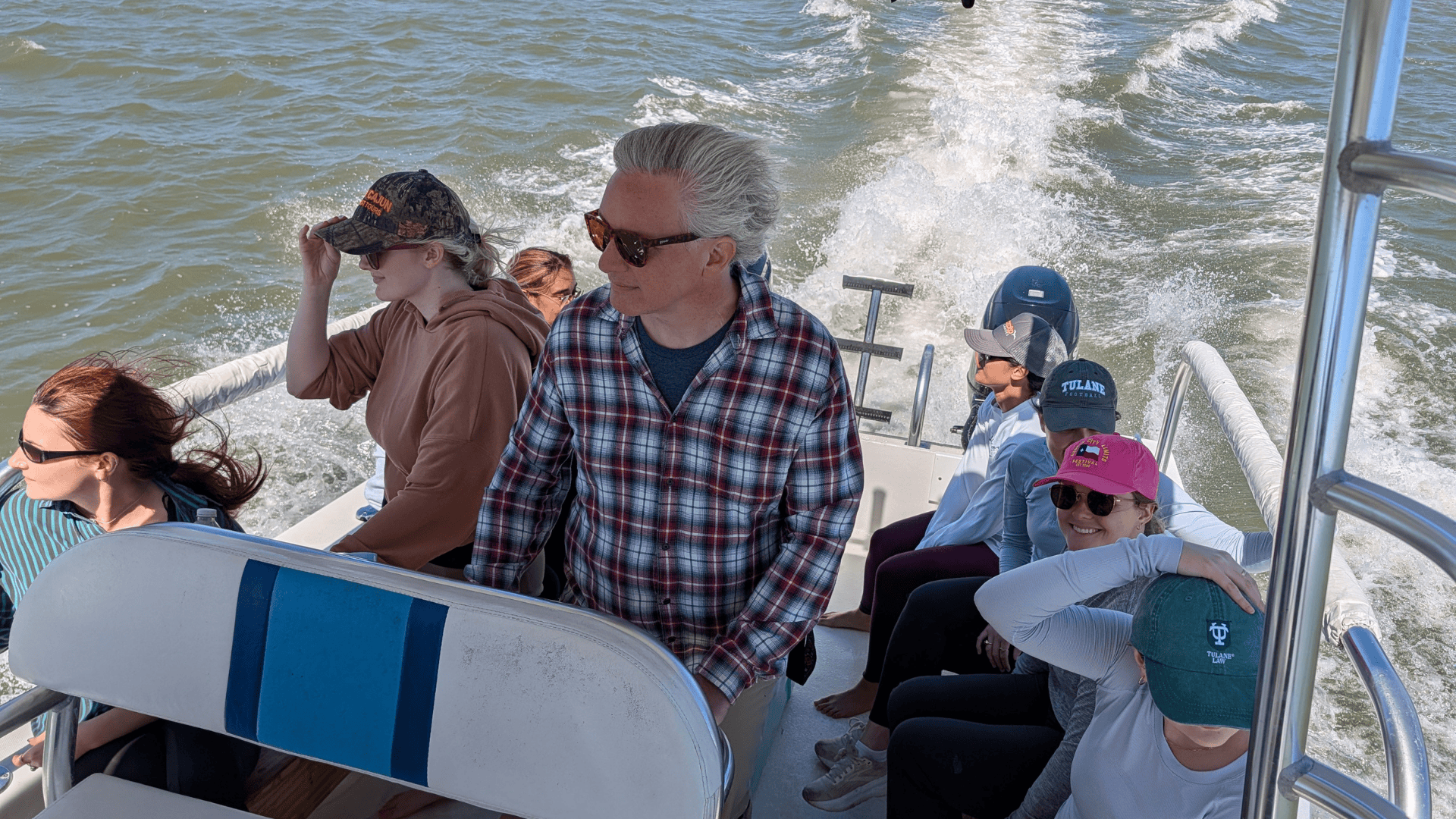 Field trip goers ride a boat through the waters of the lake.