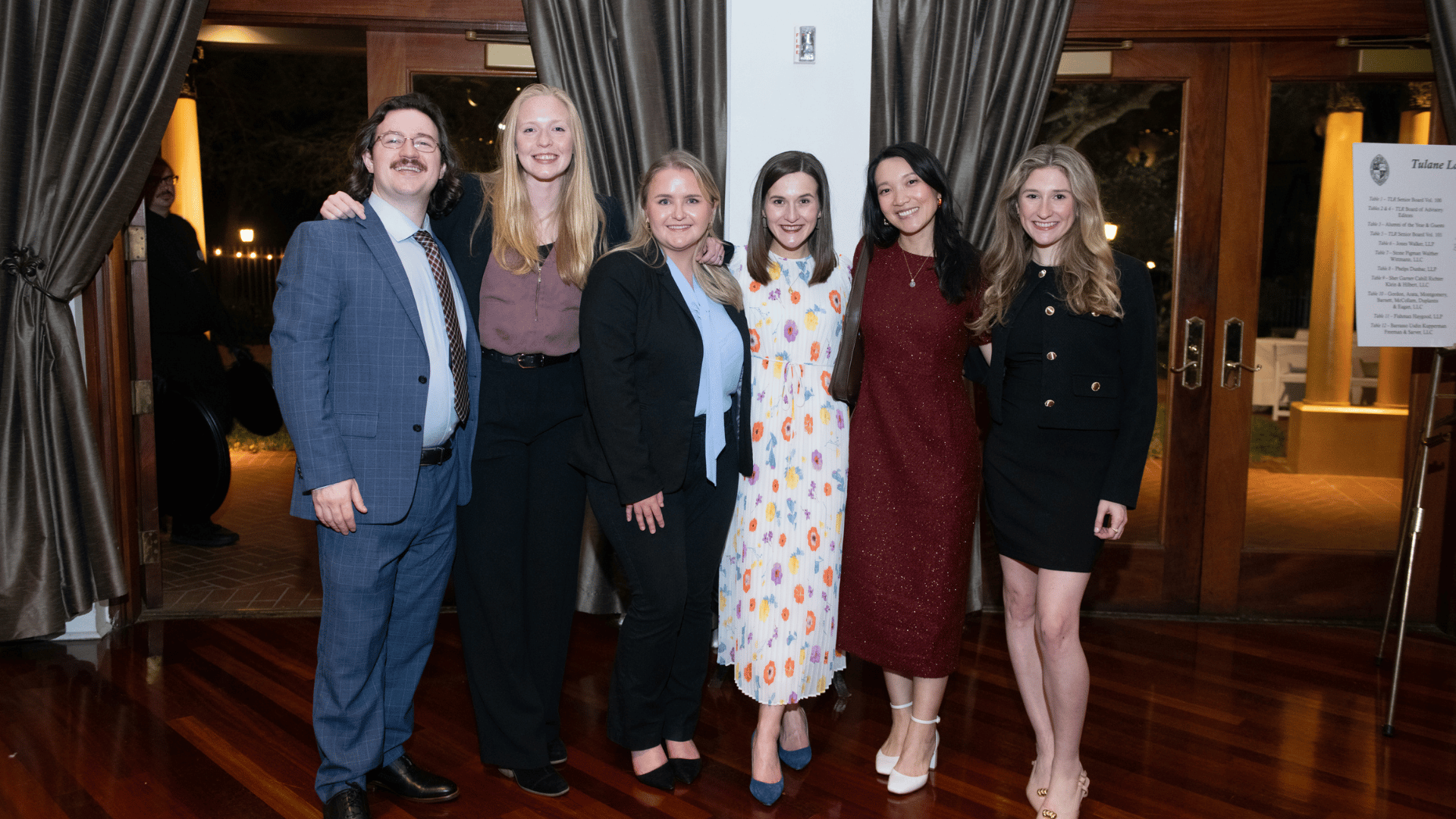 The Law Review Senior Board Members pose for a photo in a banquet space.