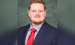 Wyatt Beaver smiles for a professional headshot.