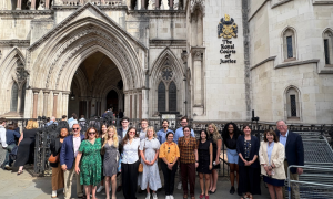 Students pose for a photo outside of the Royal Courts of London.