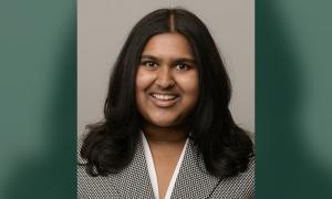 Navya Kolli smiles for a professional headshot.